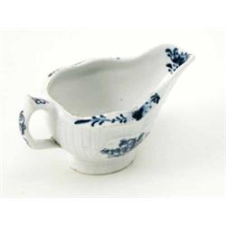 A Lowestoft small sauceboat, with moulded cartouches and fluted decoration and painted in undergl...