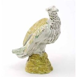 An 18th century pottery model of an eagle, possibly Whieldon, painted in green, black and ochre,...