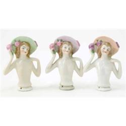 A set of 3 German porcelain tea-cosy busts, each wearing hat, paintwork varies, 3ins...