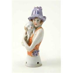 A German porcelain tea-cosy bust, lady wearing mauve hat, holding dog, 3.5ins...