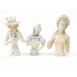 Three various German porcelain tea-cosy busts, lady wearing large bonnet, 5ins, nude lady, 5.5ins...