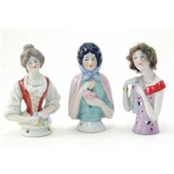 Three various German porcelain tea-cosy busts, lady with natural hair, lady with rust waistcoat a...