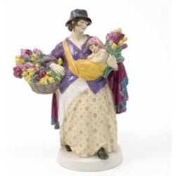A Charles Vyse pottery group; The Tulip Seller, standing with an infant and basket of flowers, mo...