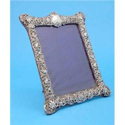 An Edwardian silver mounted photograph frame, with cartouche shape crest and foliate border, Birm...