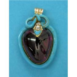 A Victorian gold heart shape pendant, set with a carbuncle framed by a blue enamel snake motif, t...