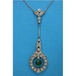 An Edwardian emerald and diamond pendant necklace, designed as a millegrain set cabochon emerald,...