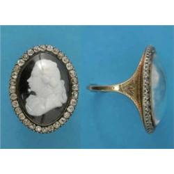 A Georgian gold ring, mounted with an oval carved onyx cameo under crystal, depicting a profile p...