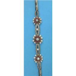 An Edwardian ruby, diamond and pearl bracelet, designed as 3 graduated flowerheads spaced by nave...