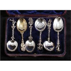 A case of six matched Dutch 17th and 18th Century silver gilt tablespoons, cast figural finials a...