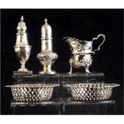 A George III baluster sugar castor, spiral knop finial to pull off cover, foliate embossed decora...