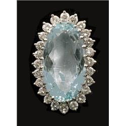 An oval cluster ring, set with centre aquamarine measuring approximately 23.5 x 12.5 x 8mm, surro...