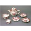 Image 1 : A famille rose export teapot and stand; a slop bowl; two saucers and a tea bowl....