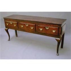 An early 18th century oak dresser, having moulded top over three short drawers, on cabriole legs...