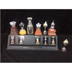 7 MINI REPLICA NHL TROHIES WITH DISPLAY STAND