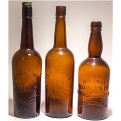 Three Embossed Western Whiskey Bottles