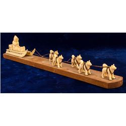 Ivory Dog Team Pulling Sled