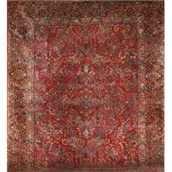 Sarouk Rug, Second Quarter 20th Century, Red ground with floral spray and flowering urn field...