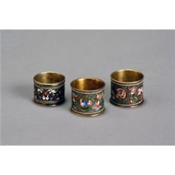 Three Russian CloisonnT Enamel Silver-Gilt Napkin Rings, Late 19th Century, Consisting of a p...