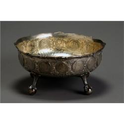 German Silver Coin Mounted Center Bowl, Circa 1911, The circular bowl mounted around the exte...