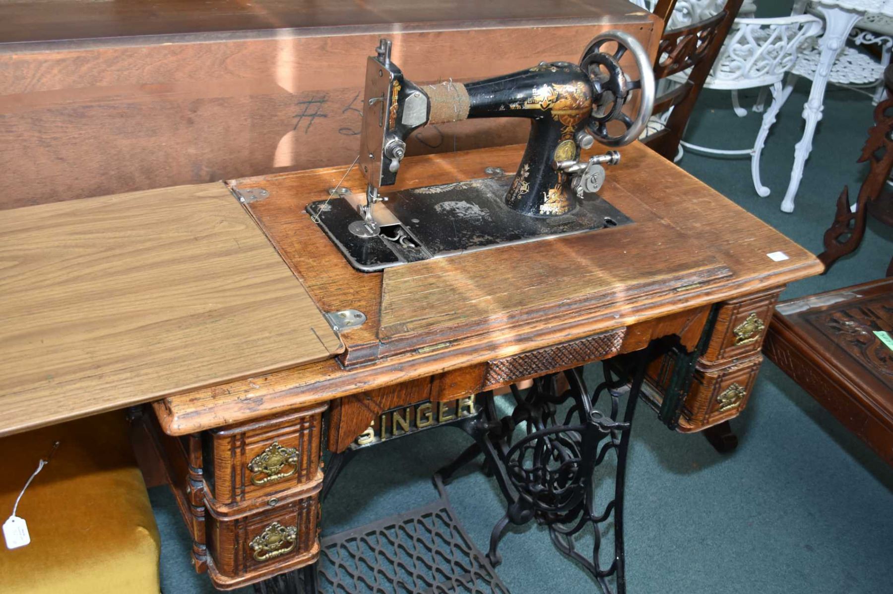 Singer treadle sewing machine in cast and oak and an