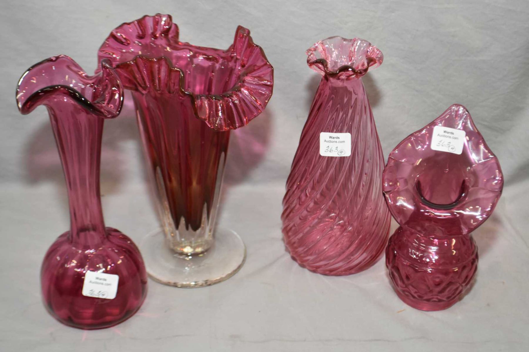 Selection Of Cranberry Glass Including Ruffled Edged Trumpet Vase