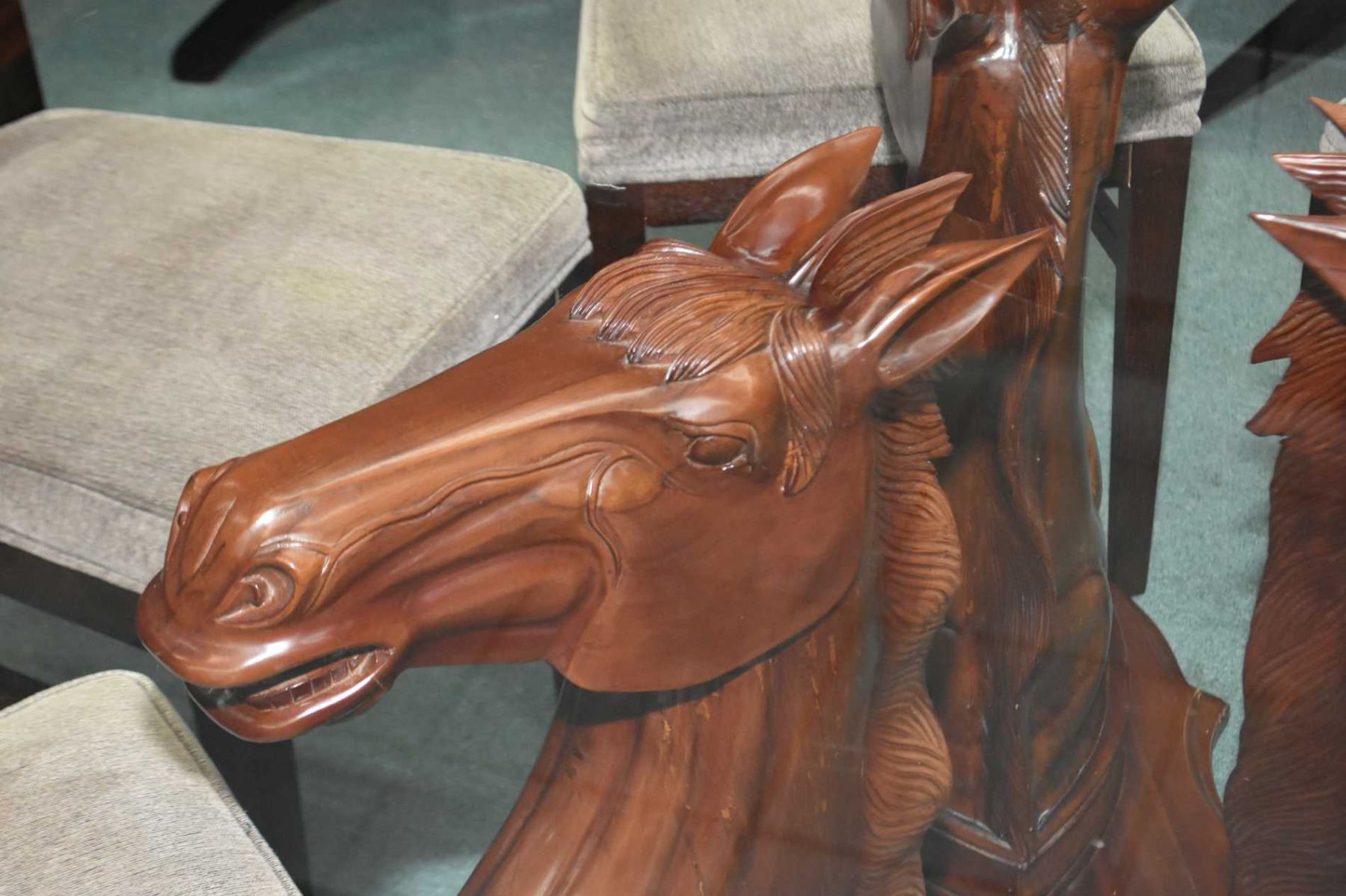 60" diameter glass topped dining table with triple horse head motif