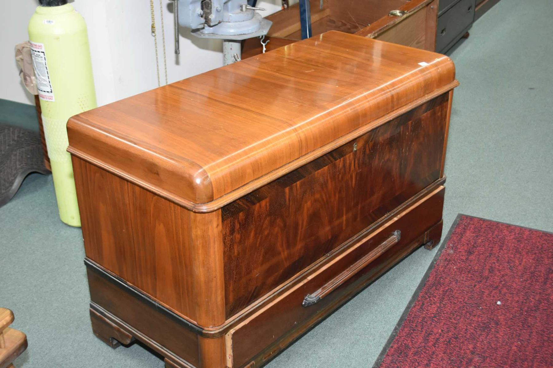 Wood waterfall front cedar lined chest made by Heirloom with drawer on base