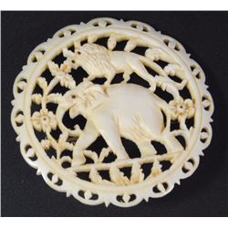 Old ivory brooch, lion and elephant