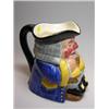 Image 1 : A Clarice Cliff toby jug, he sits with foaming jug of ale and wears yellow trimmed blue coat, print.