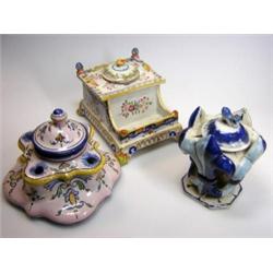 Three Quimper style inkwells, one in tones of blue modelled with fleur de lys sides, HB mark, 9.5cm.