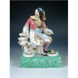A mid 19th century Paris figural inkstand surmounted by an Ottoman seated on a gilt rock, the colou.