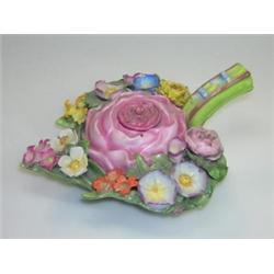 A late 19th century Sitzendorf flower encrusted inkwell and cover, modelled as a leaf filled with f.