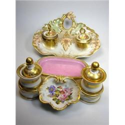 A mid 19th century KPM inkstand, red fruits behind the gilt pen trough flanking the two receivers a.