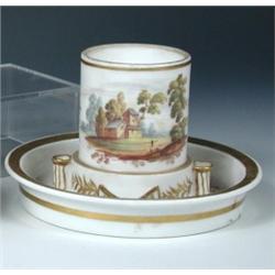 A mid 19th century Paris porcelain inkwell, the cylindrical bird feeder type receiver painted with..
