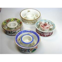 Four various Paris porcelain inkwells, each with flared cylindrical sides, three painted with flowe.