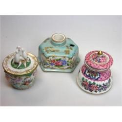 An early 20th century Dresden inkwell and cover, the bucket shape painted with lovers between the ma