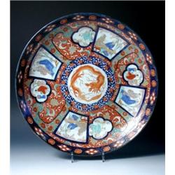 An early 20th century Japanese Imari charger, four tapering square figural panels linked with other.