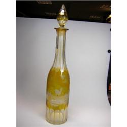 An early 20th century Bohemian amber overlay decanter and stopper, both engraved with trees, the cy.