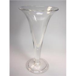 A late 18th century drinking glass, the large trumpet bowl on teared stem tapering to the folded fo.