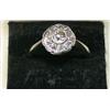 Image 1 : A diamond cluster ring with central old cut diamond within a circle of ten smaller stones £500-700..