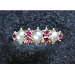 A late Victorian/Edwardian 18ct gold ring set with half pearls and rubies £100-150...