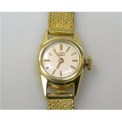 A lady's 18ct gold cased wristwatch by Longines with circular silvered dial with gold baton numeral.