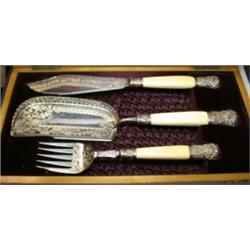 A Victorian electroplate three piece set of fish servers including a knife, fork and slice, the bla.