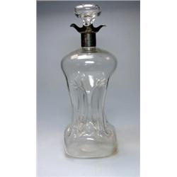 An Edwardian plain glass dimple decanter, silver mounted with quadruple spouts, London 1901, 31cm h.