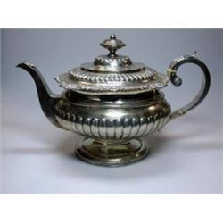 A George III Scottish silver teapot by J McKay, Edinburgh 1817, of compressed circular form, the lo.