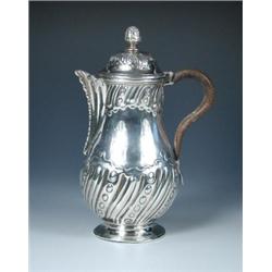 A George II silver hot water jug by William Shaw and William Priest, London 1751, of baluster shape.