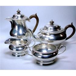 A matched silver four piece teaset by Edward Barnard & Sons, comprising: a teapot of plain compress.