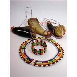 A Masai beadwork neck ornament, bangle and three medicine horns , the latter stretched with drum sk.