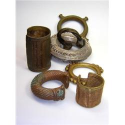 Twelve African bangles or torques, mainly cast and worked in bronze but to include two in white met.