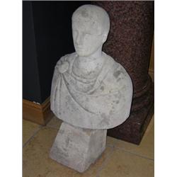 An 18th/19th century Cotswold stone bust of a Roman, his toga held by a brooch on his right shoulde.